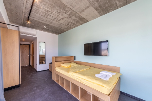 Empty dorm room with bed