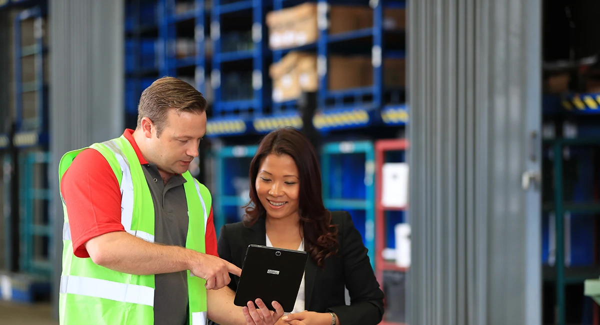 Rentokil Specialist shows customer something on his tablet