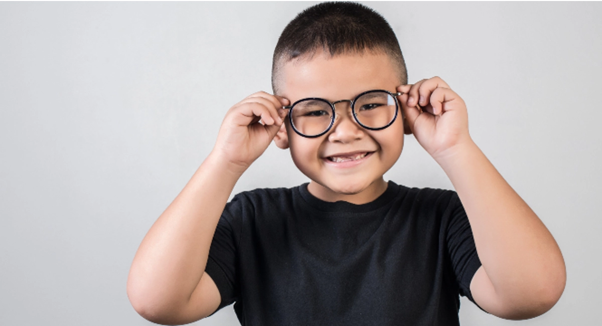 Boy laughing wearing glasses