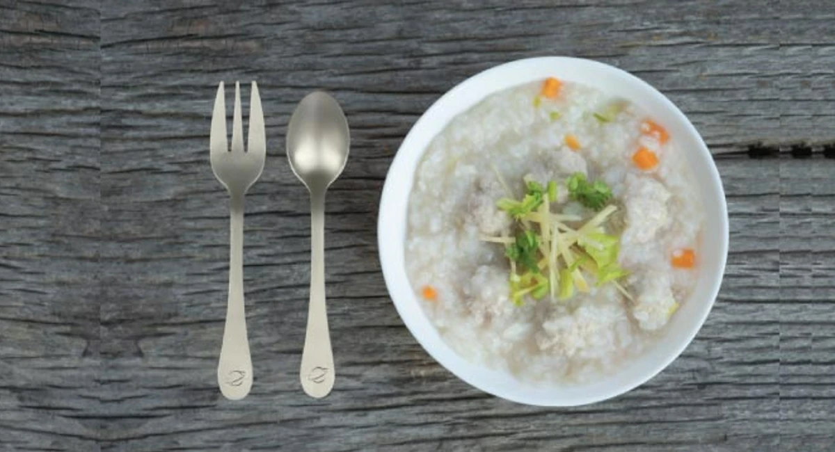 Cutlery next to a bowl of porridge