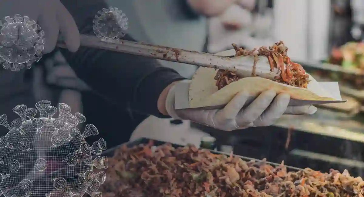person putting meat into a tortilla with tongs
