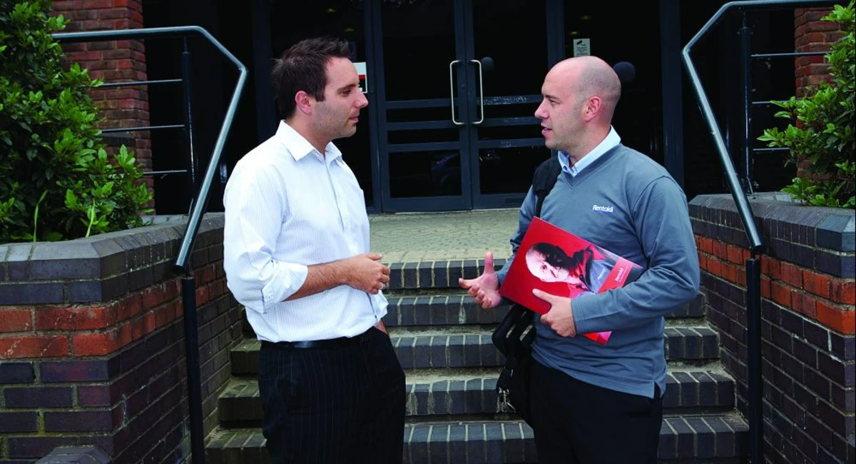 Rentokil surveyor talking with customer outside