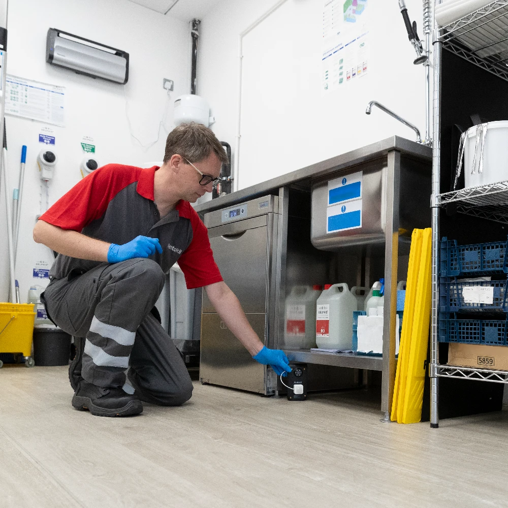 Rentokil colleague placing connected Optix device