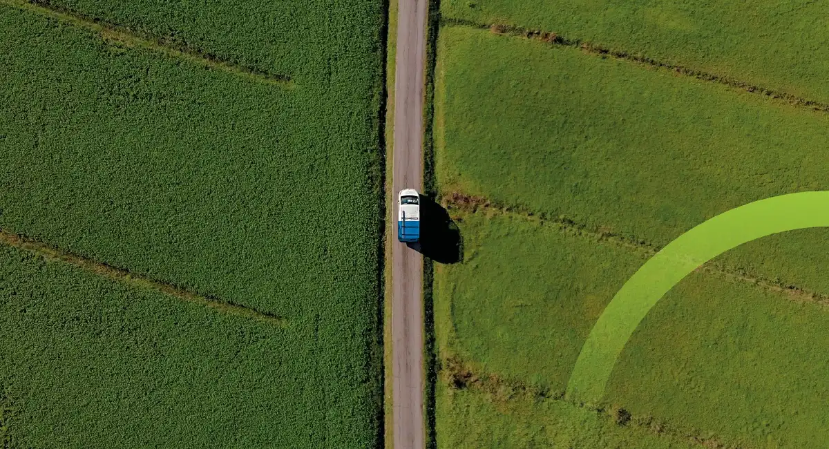 Car driving along country road with fields